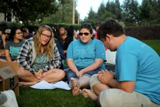Kaci Larick, Katie Bufford, Timothy Ethell pray together during the quiet time.