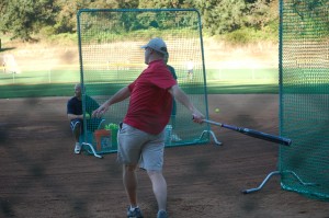 Justin Sherwood practices his swing in a warm up before the home run derby in the faculty during the faculty vs. softball team game on Thursday, Sept. 30. Photo by Sara Swenson