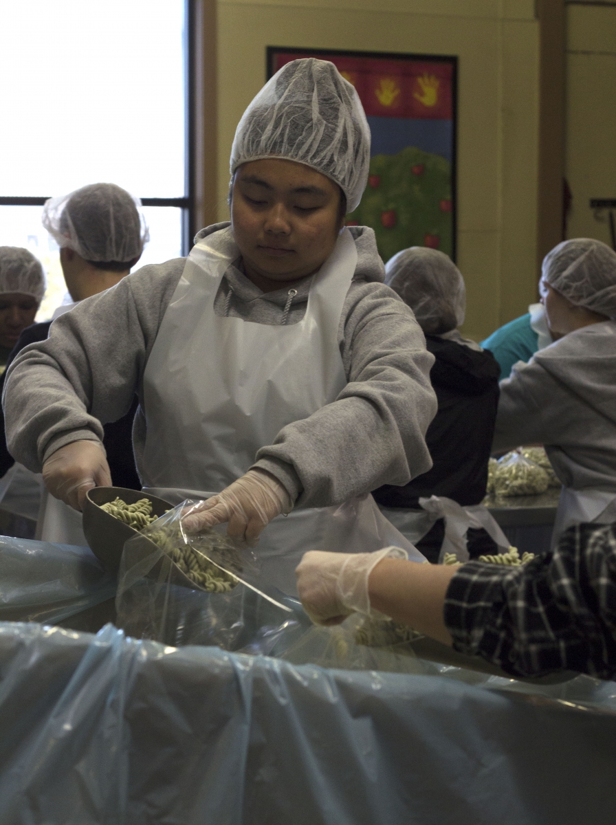 Isabel Steinhoff scooping pasta at the Marion County Food Share.   